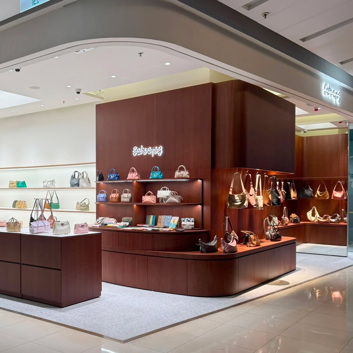 20% off full-priced handbags plus free leather accessory gift at apm store opening.